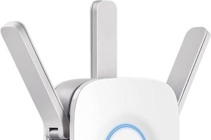 TP-Link RE550 WiFi Extender plugged into a wall socket in a modern living room