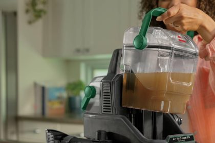 BISSELL Little Green Pet Pro Portable Carpet and Upholstery Cleaner in green and black, shown with cleaning attachments and ready for use on carpet and upholstery.