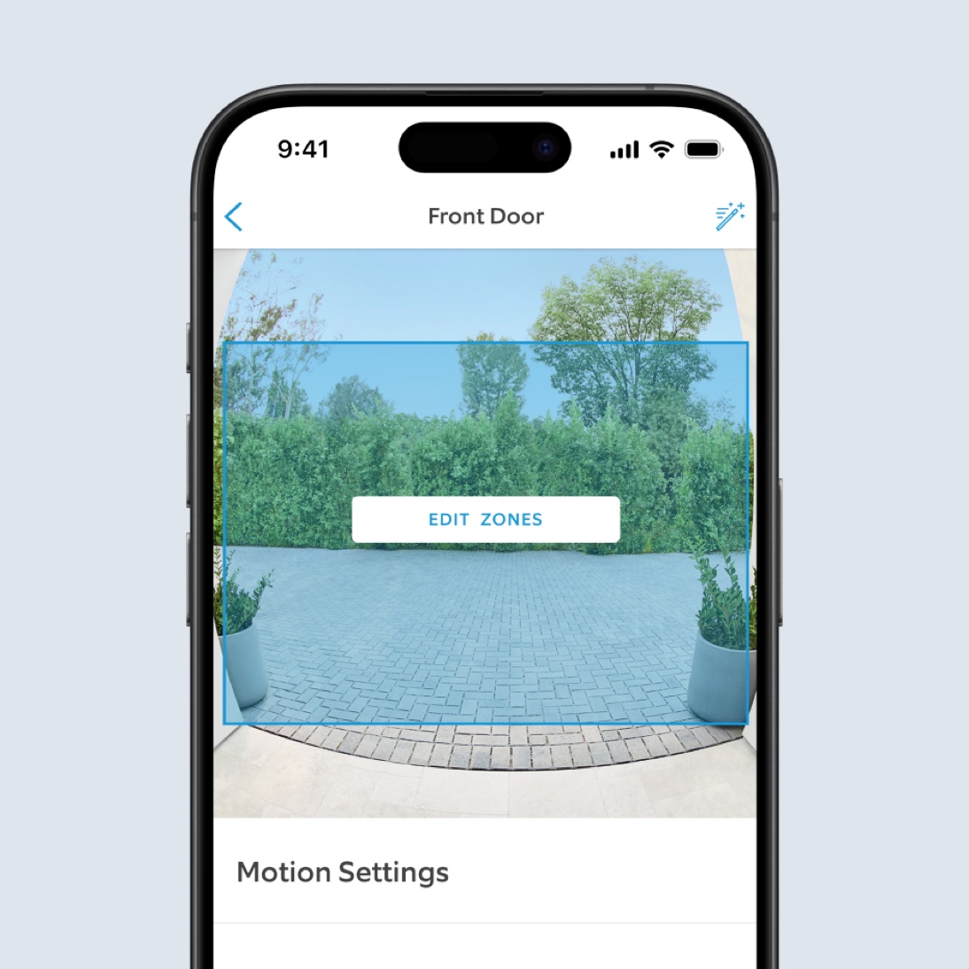 A phone screen shows video footage in the Ring App of a driveway. A blue square covers most of the image. Text reads: "Edit Zones."